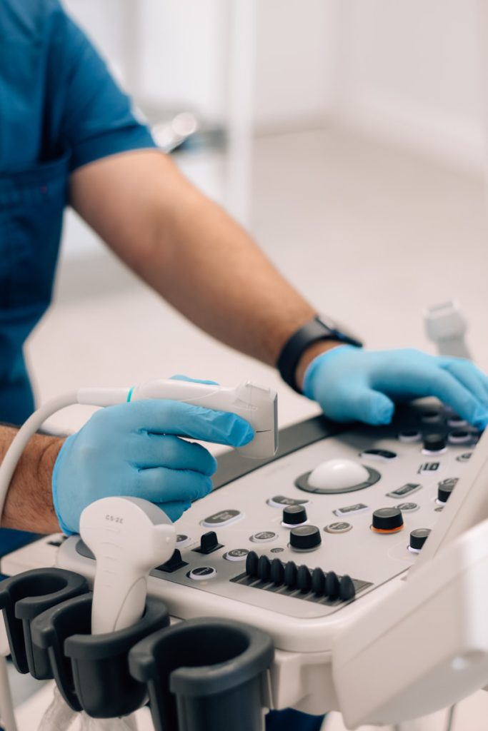 a person in blue gloves operating a machine